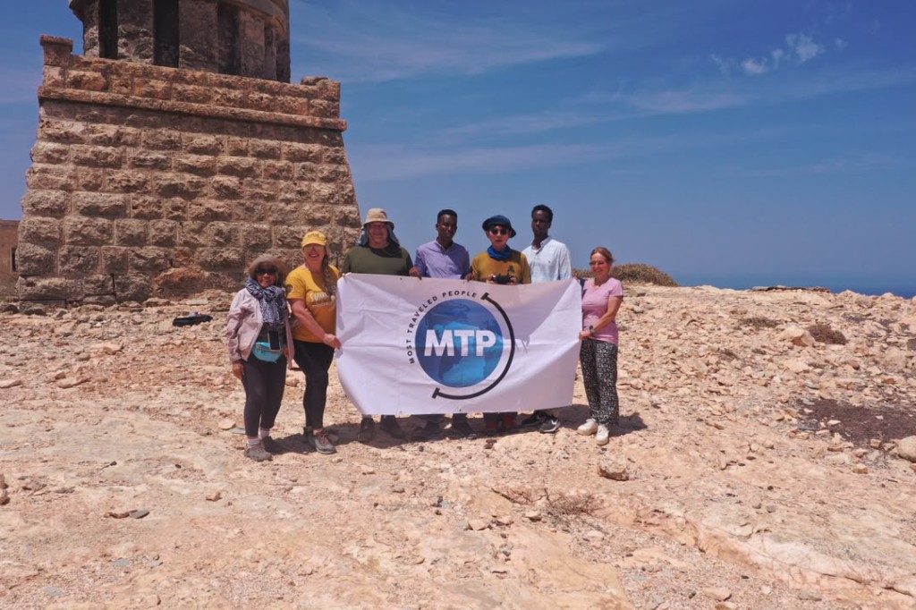 Historic lighthouse ruins with visitors